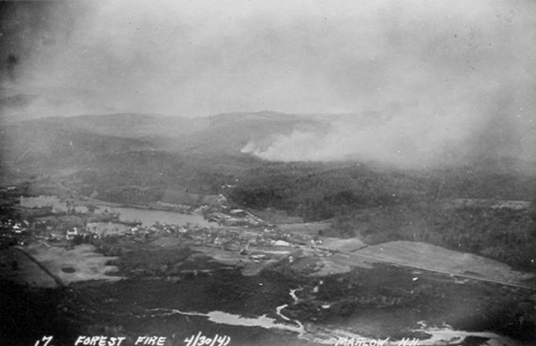 Flames threaten Marlow village during 1941 fire.